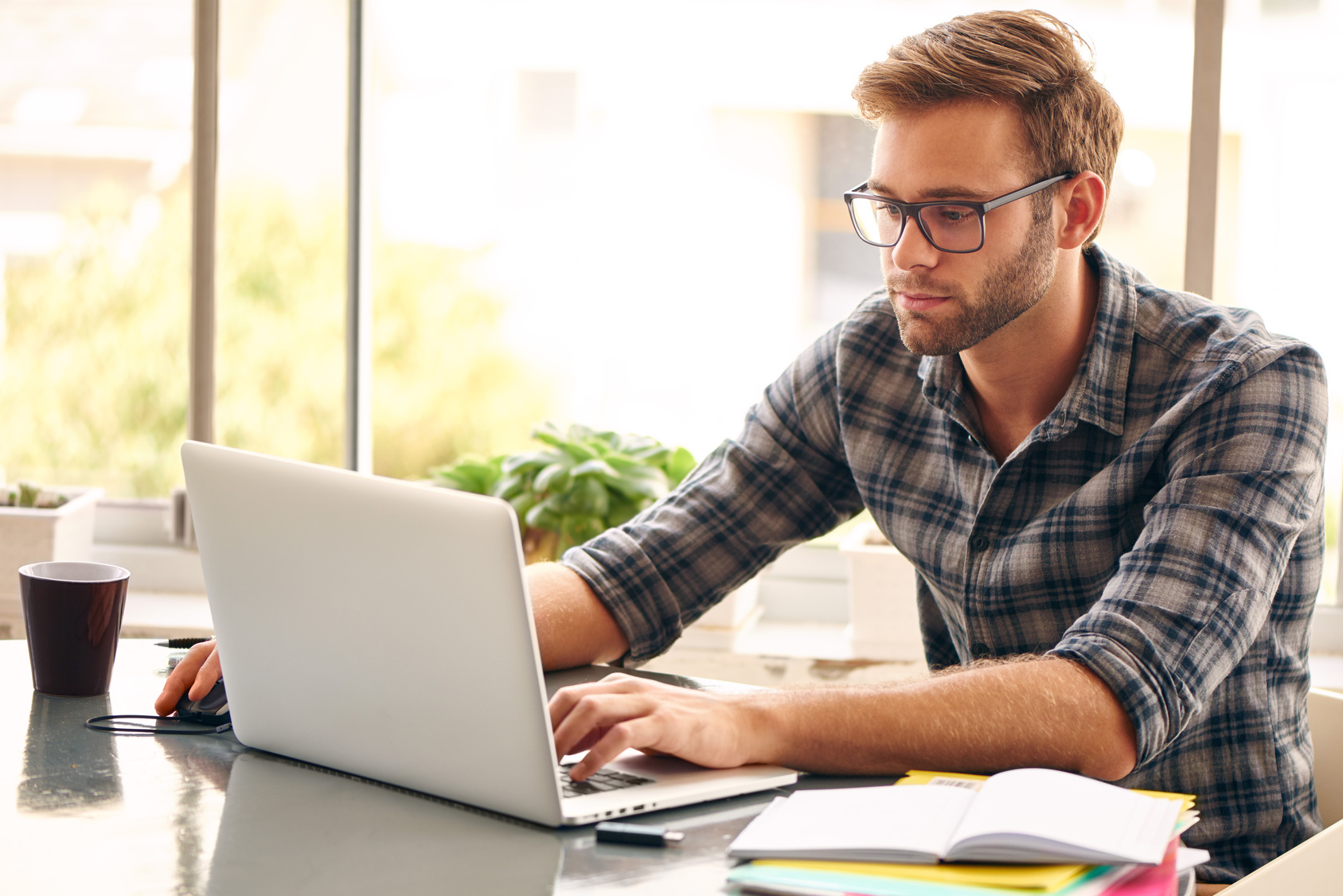Student working at his laptop in relaxed lounge atmosphere