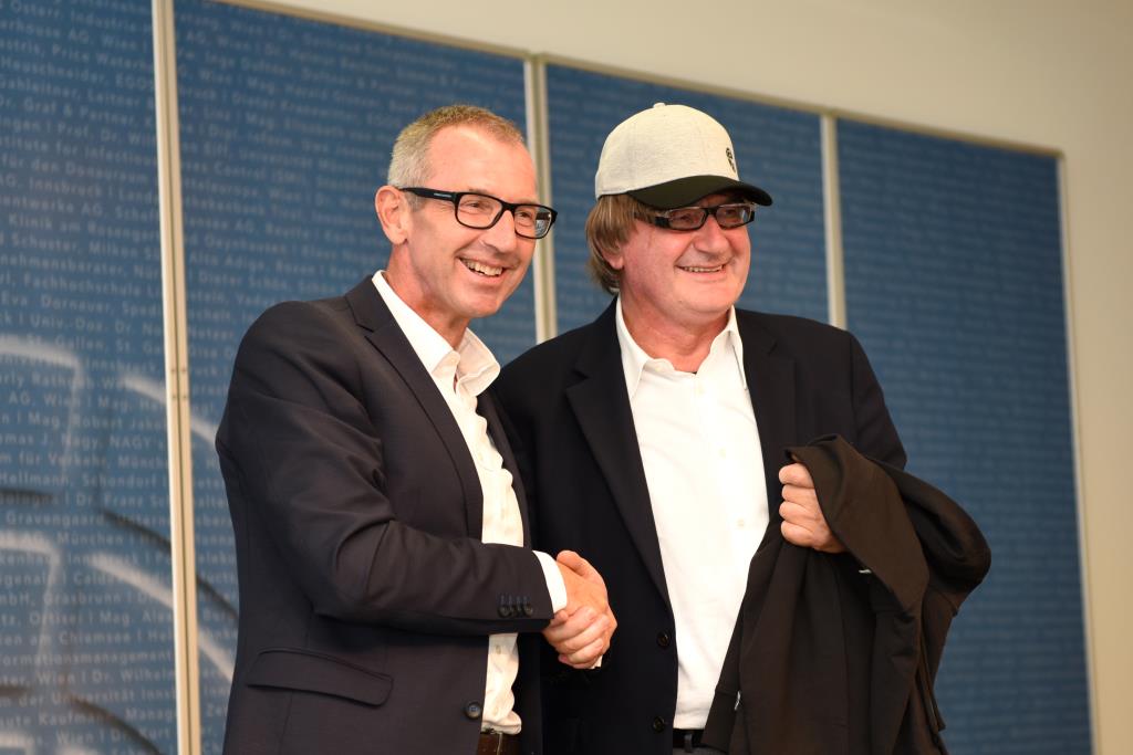 Prof. Dr. Andreas Altman and Mario Moretti-Polegato wearing an MCI baseball cap