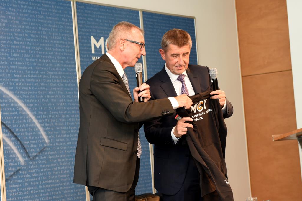 Prof. Dr. Andreas Altmann gives H.E. Andrej Babiš a MCI hoody