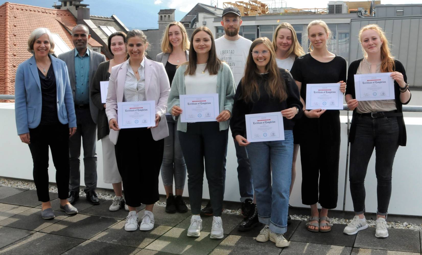 Regina Obexer (Head of MCI Center for Responsible Management & Social Impact), Belachew Gebrewold (Head of Department and Study Programs Social Work) with the student advocacy seminar project group ©MCI/Danzl